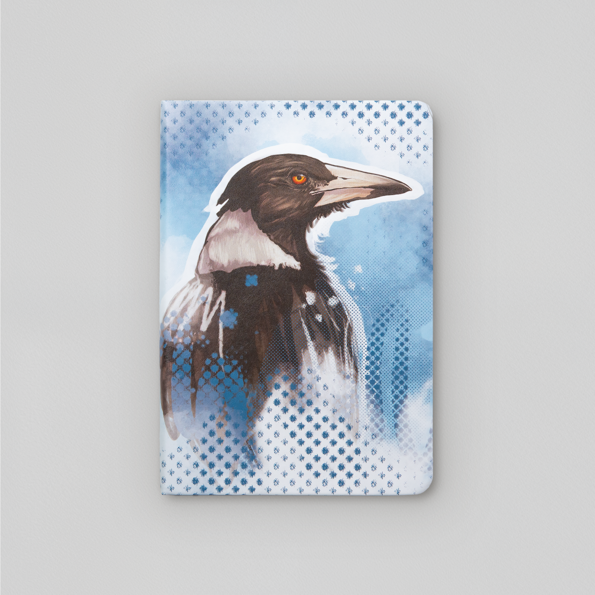 A5 leatherette journal featuring magpie artwork on blue background. Artwork by local artist Tara Leslie