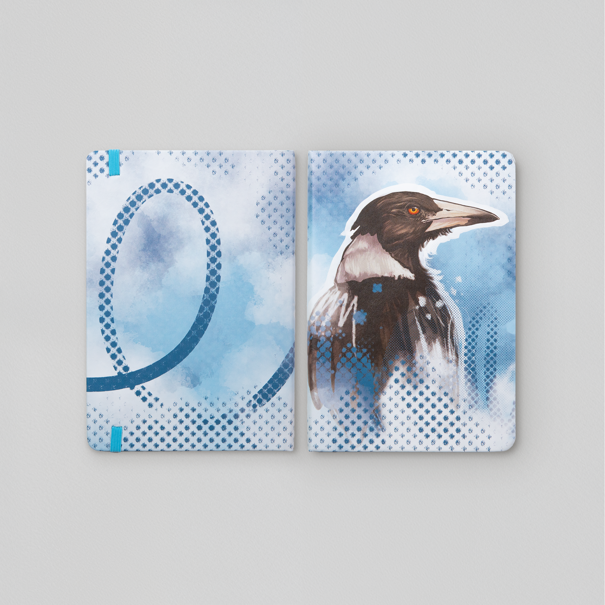 A5 leatherette journal featuring magpie artwork on blue background. Artwork by local artist Tara Leslie