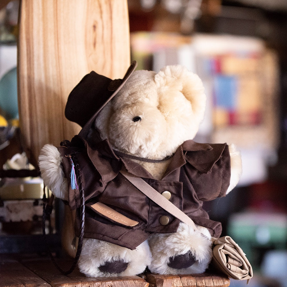 Tambo Teddy wearing oilskin jacket, outback hat, bag and whip