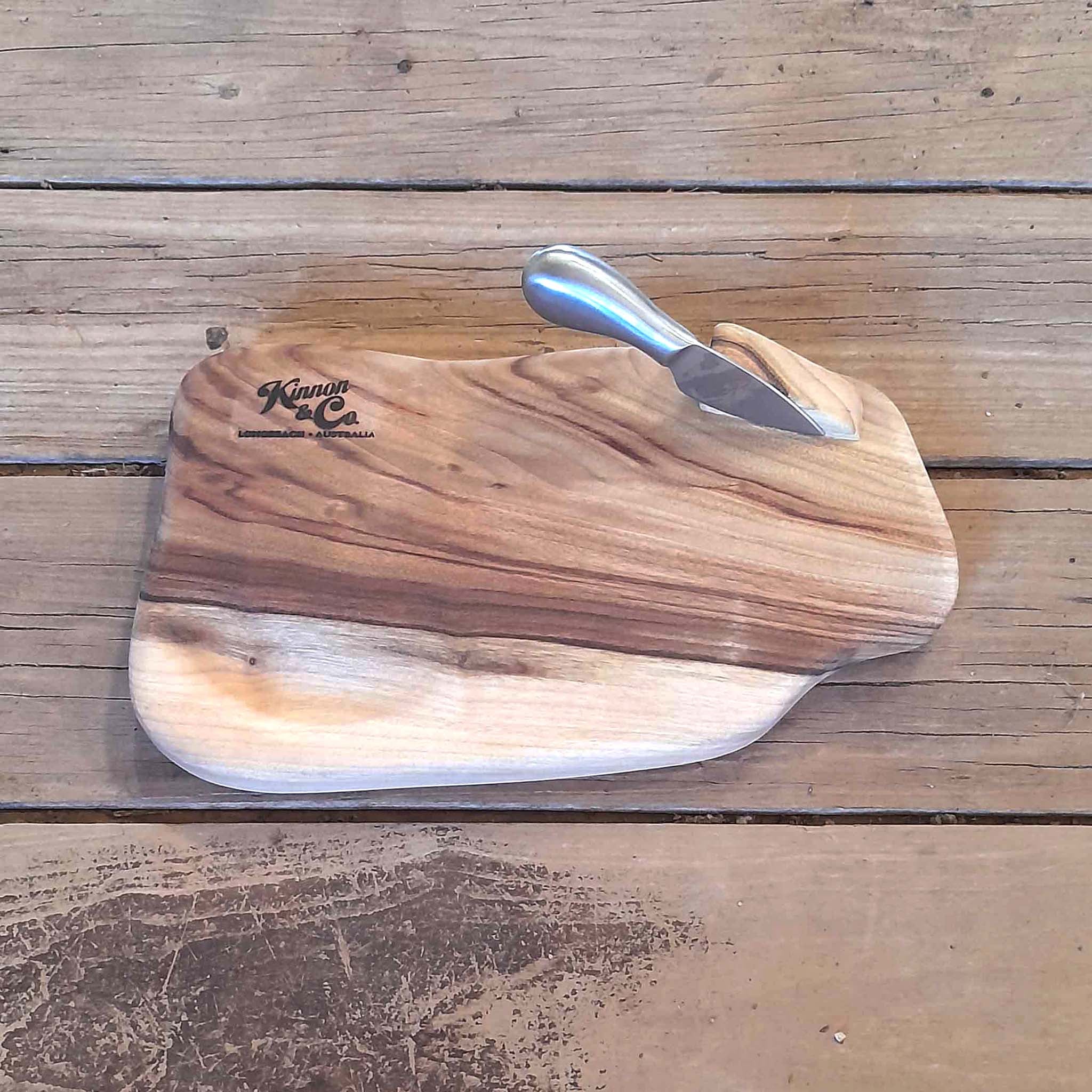 Kinnon and Co branded Camphor Laurel Cheeseboard with one brushed stainless steel knife.