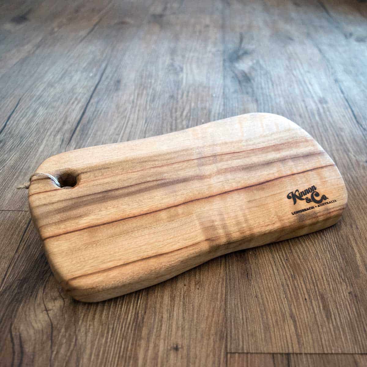 Kinnon and Co branded Small Camphor Laurel Freeform Cutting Board with hole 