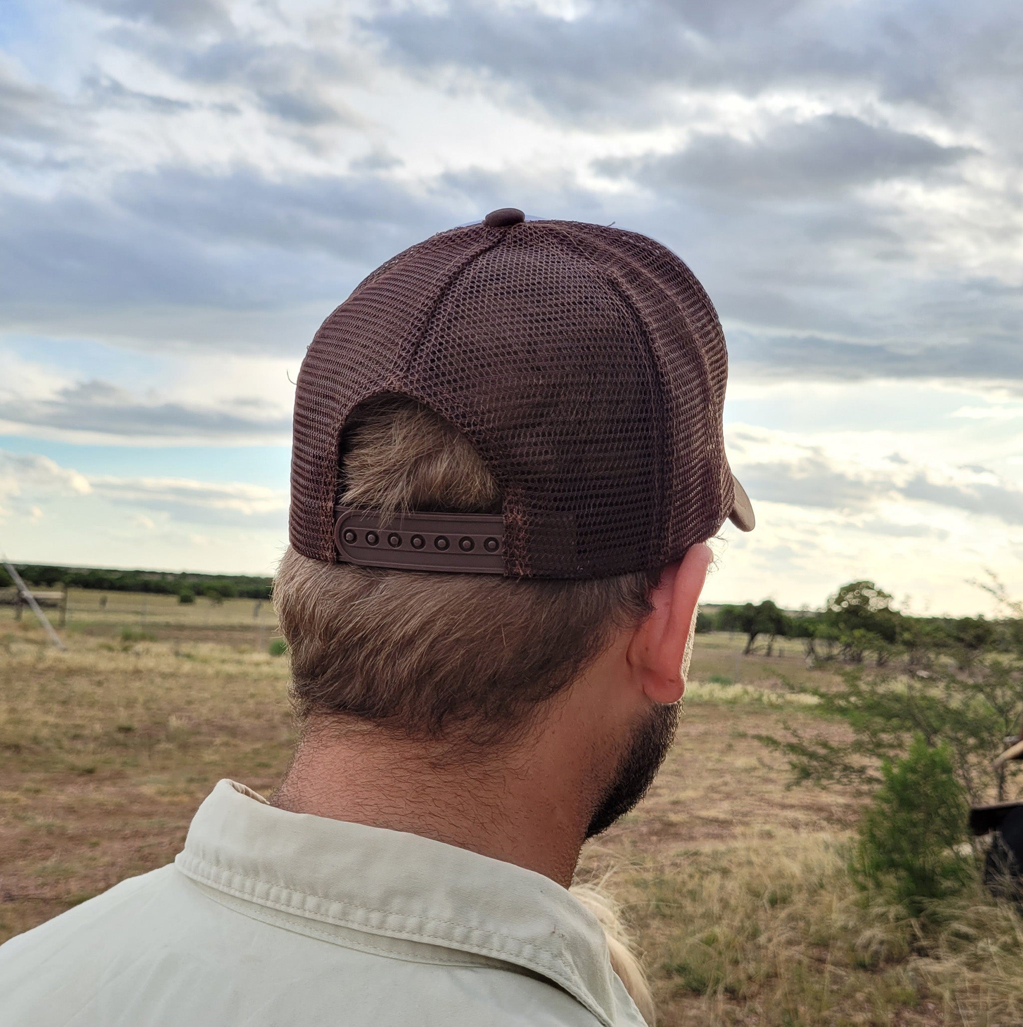 The Station Store Truckers cap brown and white showing plastic closure.