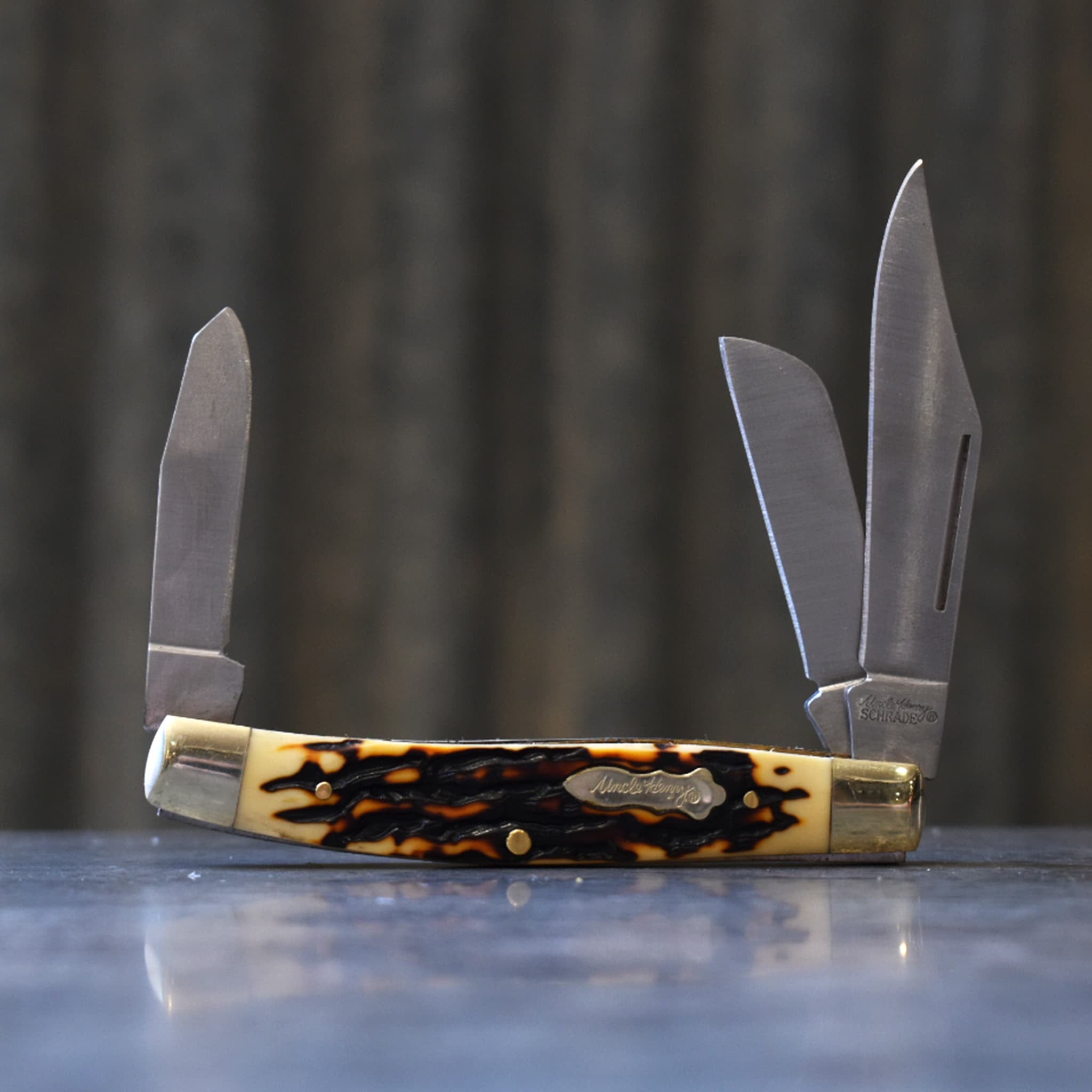 Uncle Henry pocket knife featuring three open blades.
