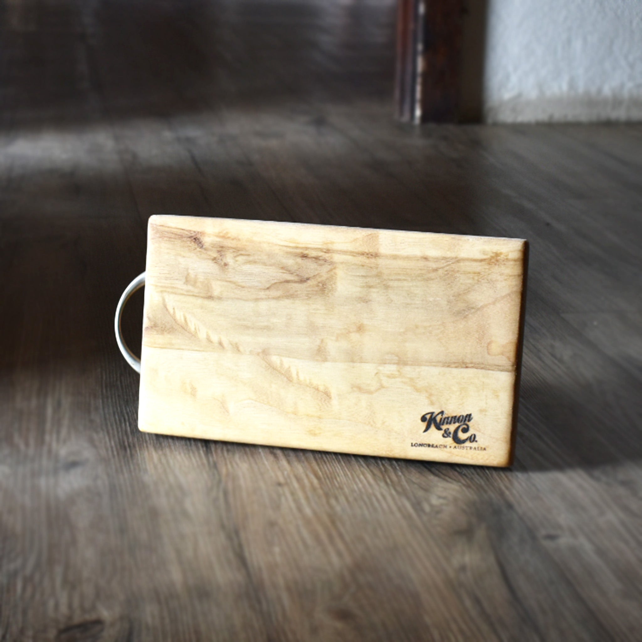 Wooden chopping board on timber floor boards