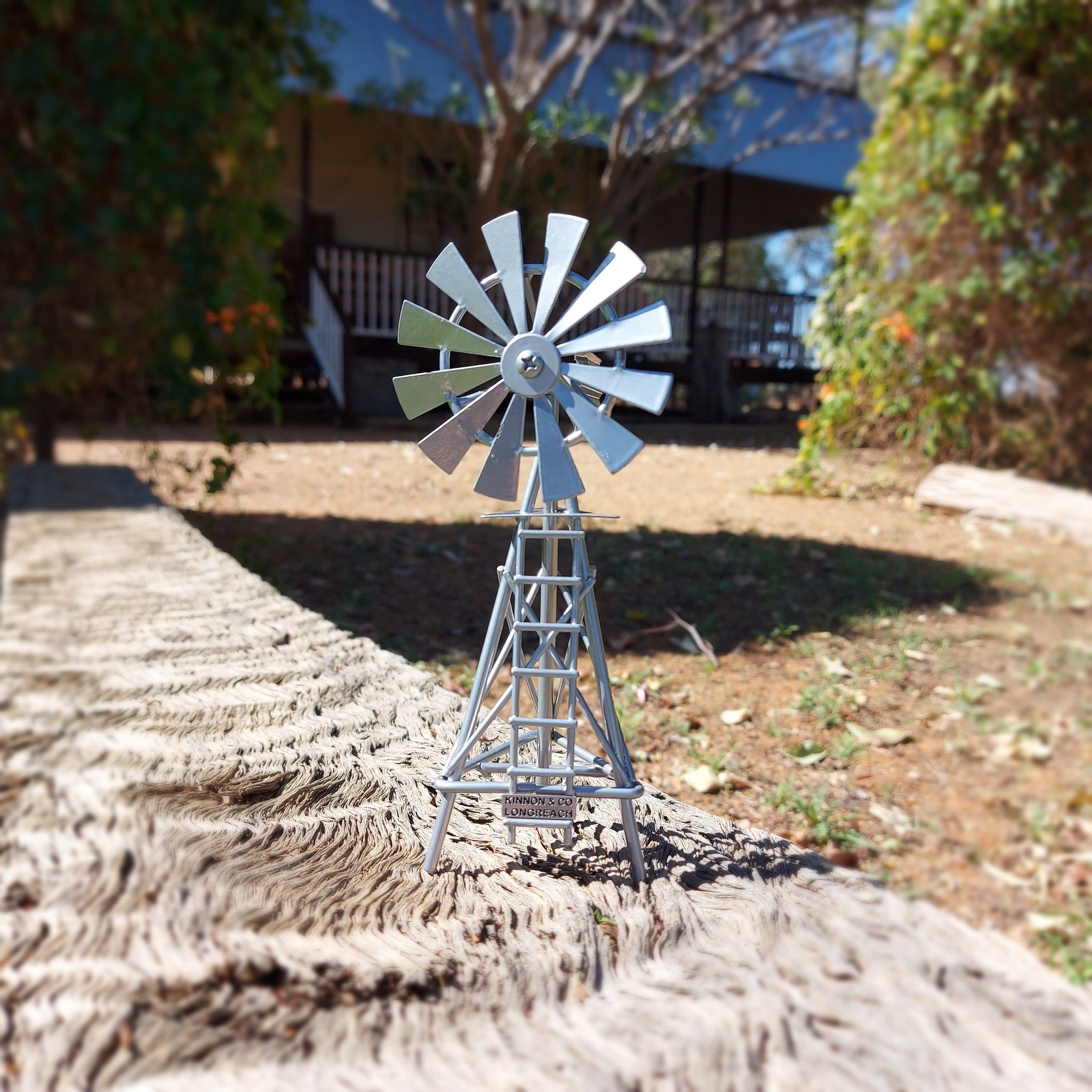 Small Silver Metal Windmill replica with Kinnon and Co Longreach nameplate attached