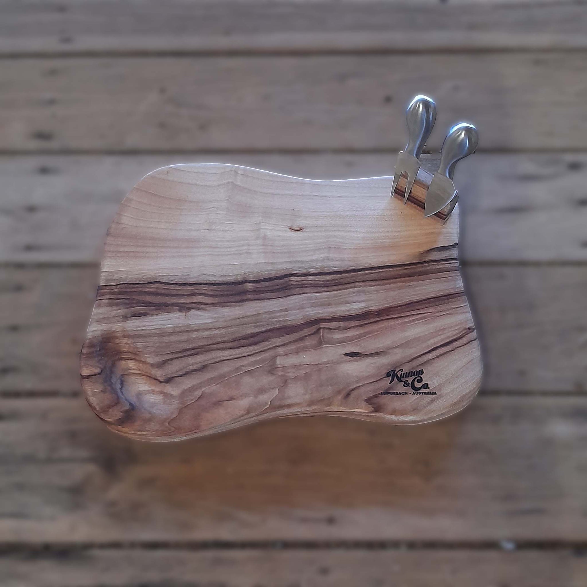Kinnon and Co branded Camphor Laurel Cheeseboard Freeforrm with two stainless steel tools. 