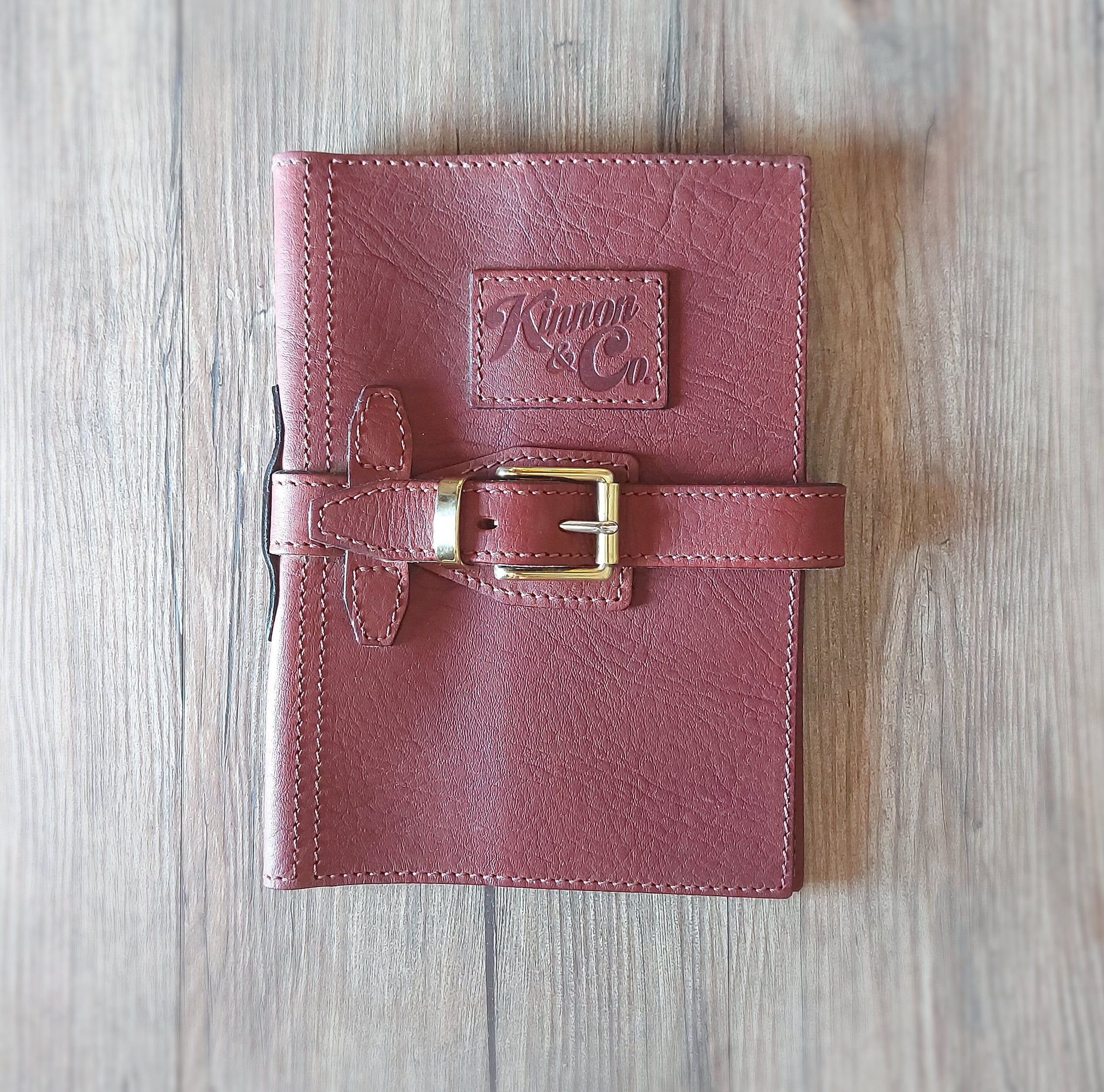 Kinnon and Co branded A5 leather diary cover with strap