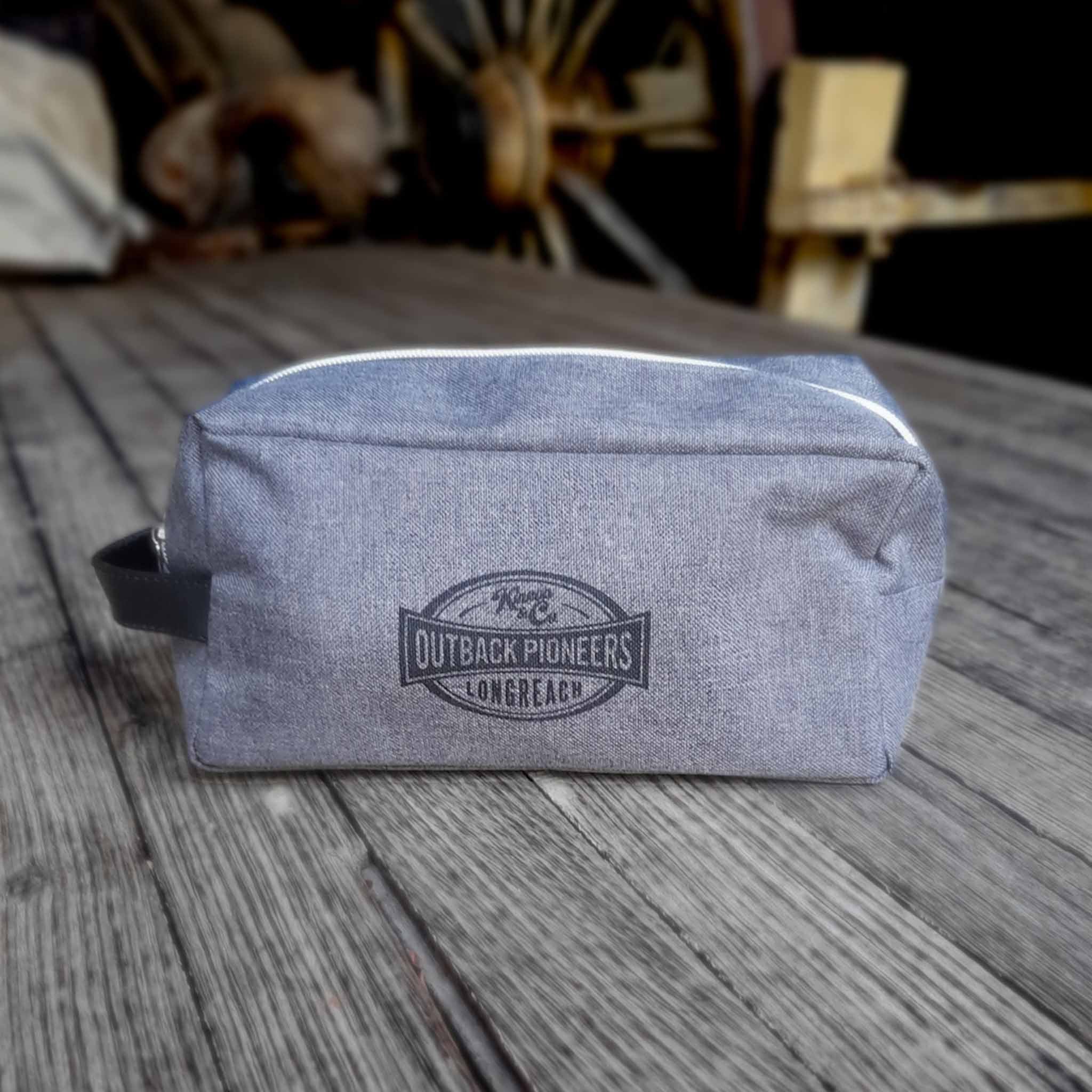 Outback Pioneers branded Toiletry Bag, grey heathered finish and carry handle. Front