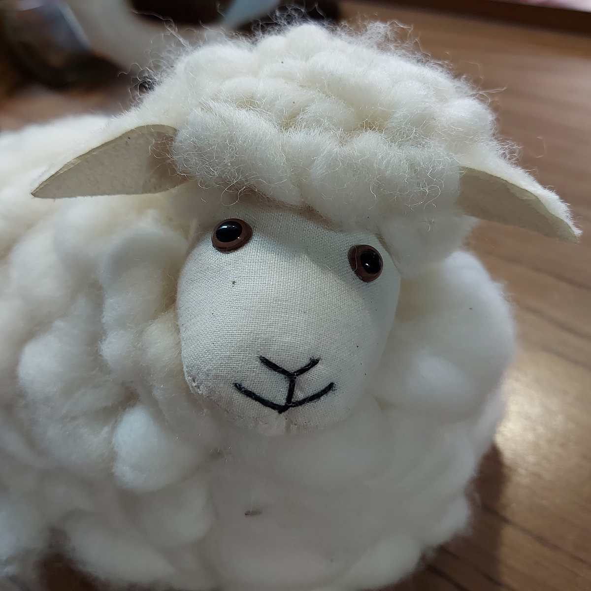 Face view of Handmade soft toy sheep with noise