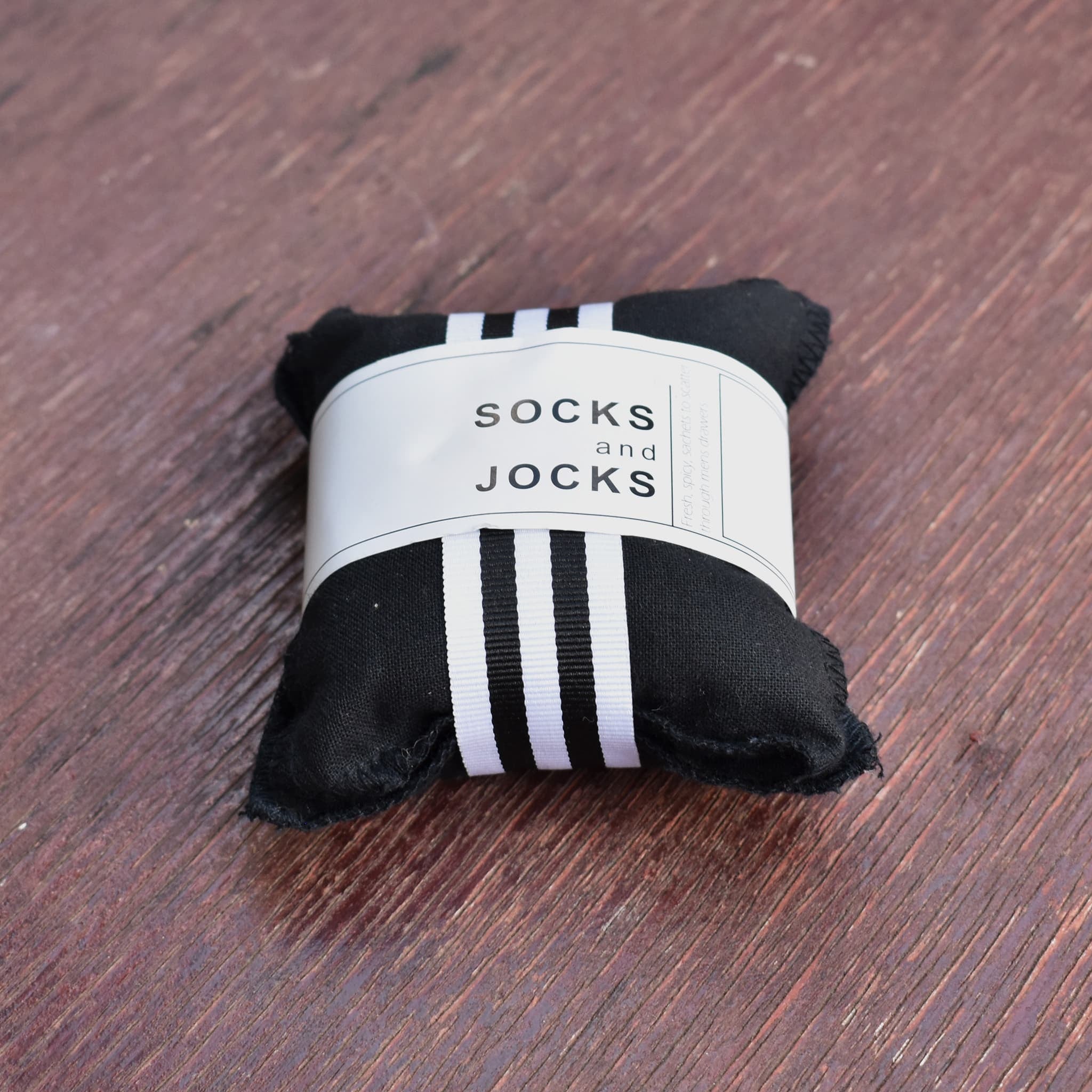 Socks and jocks drawer sachet in black fabric. 