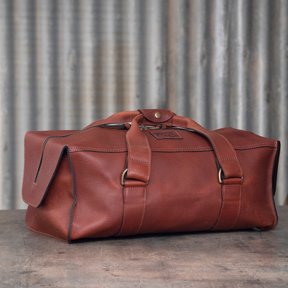Kinnon and Co branded Small Tan Leather Weekender Bag.